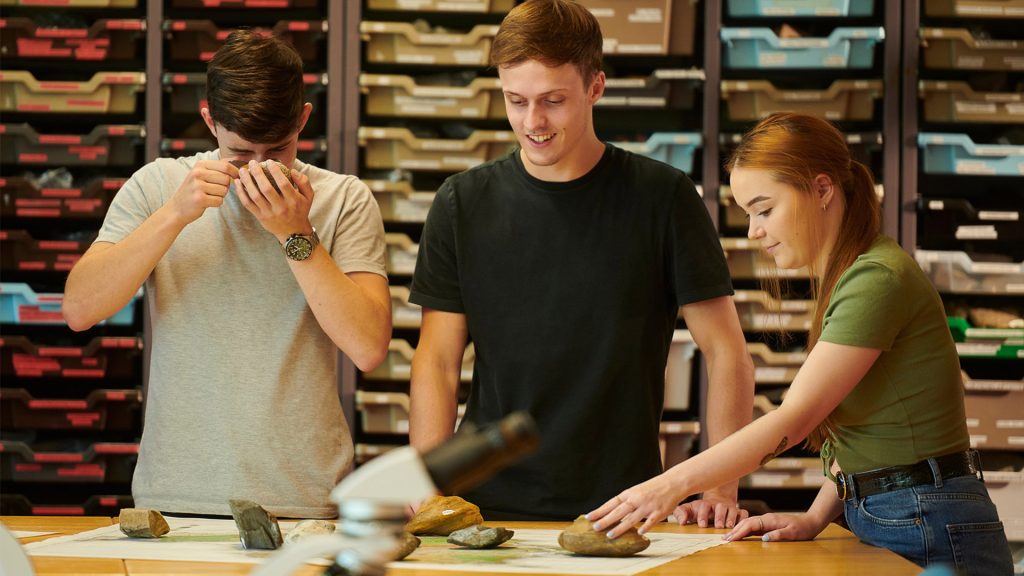 A group of geology students examining rocks using the equipment