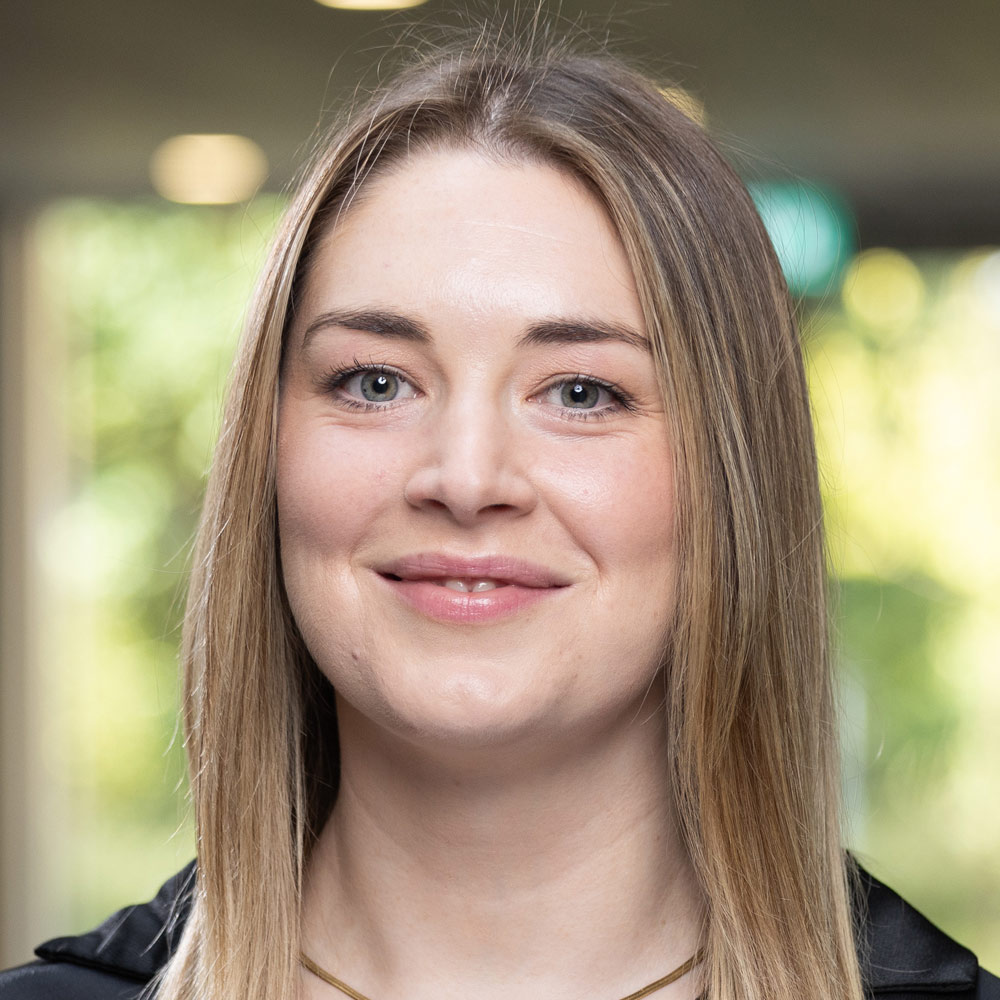 Psychology researcher Dr Lauren McGale smiles at the camera.