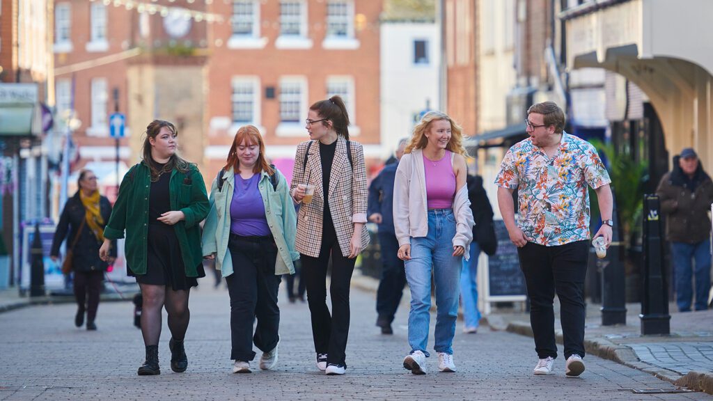 group of students chatting walking through Ormskirk town centre