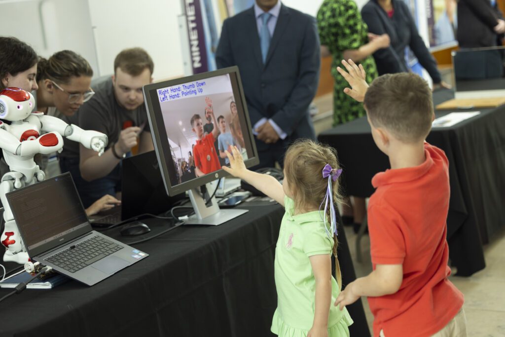 Children getting to know Stefan the robot