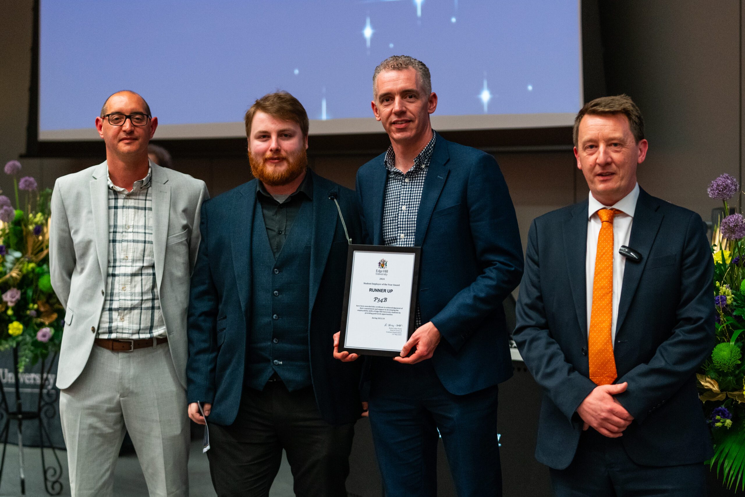 P34B and student Christopher Peel with their framed certificate, photographed with Pro Vice-Chancellor, Liam Owens.