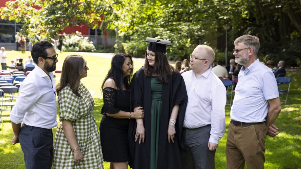 Emily Stirrup smiles while surrounded by family and friends.