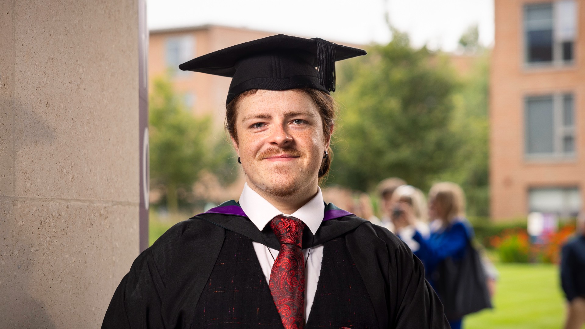 Lewis Melville facing camera in his cap and gown