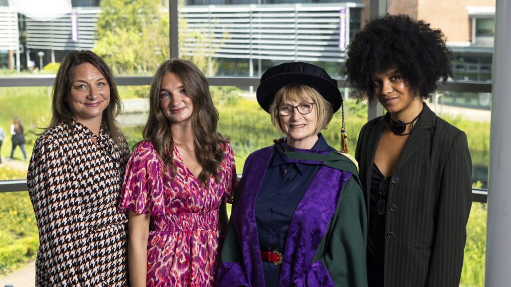 Dame Louise Ellman wears her ceremonial gowns and stands with three family members.