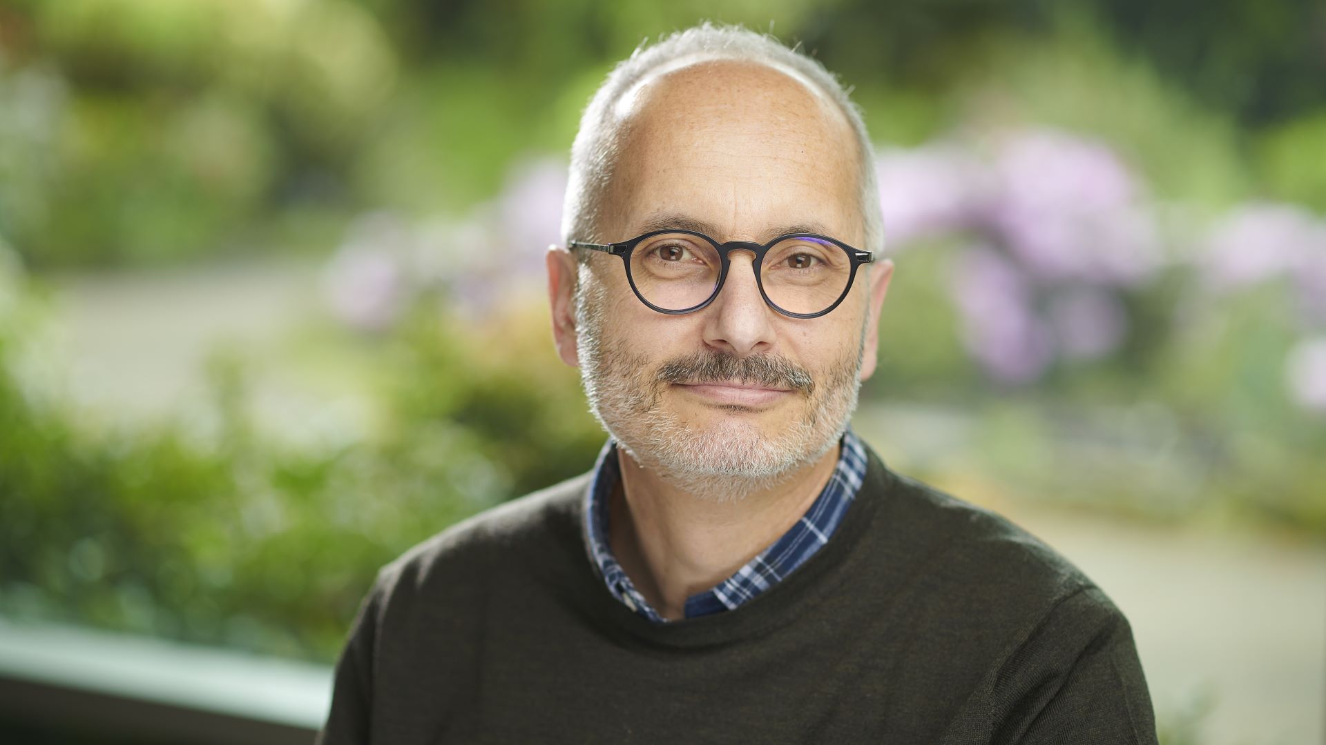 Profile shot of Marcello Trovati with green campus background