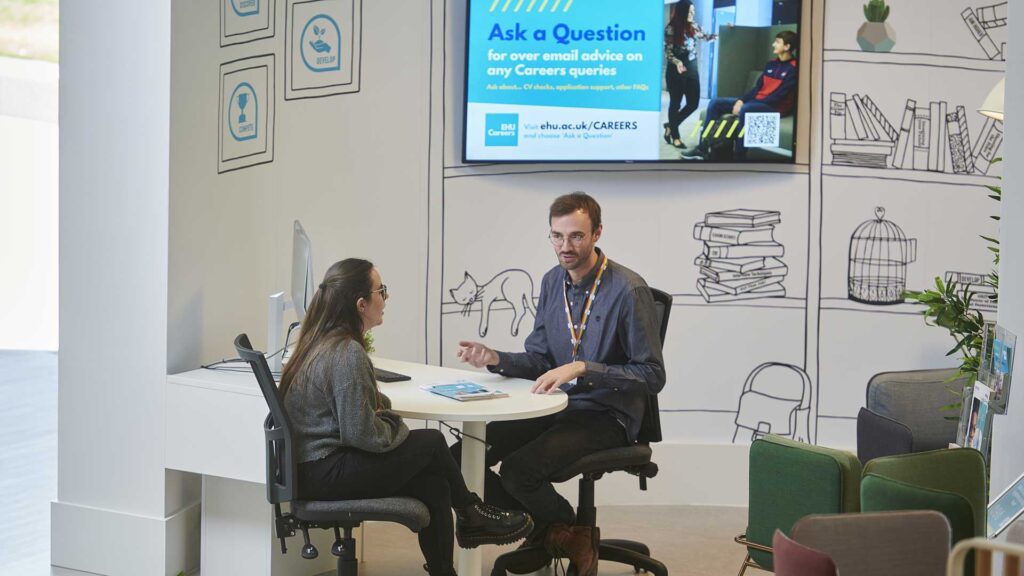 A student seeks advice from a member of the careers team in Career Corner.