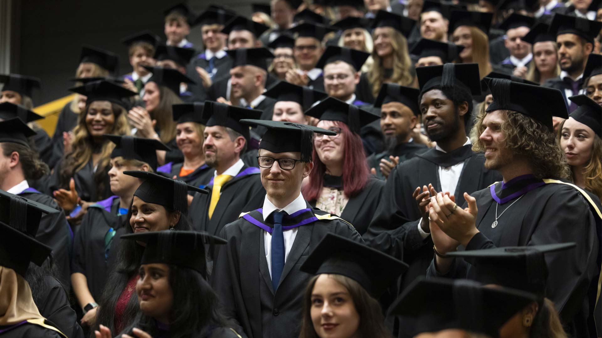 Students applaud during a graduation ceremony