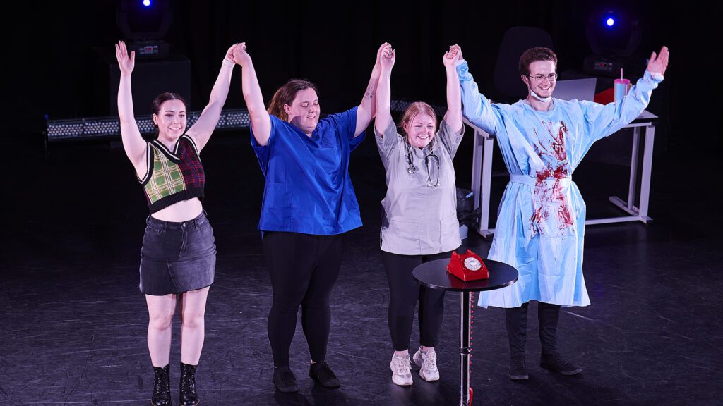 Edge Hill students  take a bow on stage after a performance.