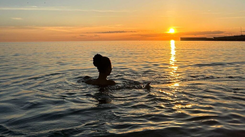 Tatiana enjoys a sunset swim.