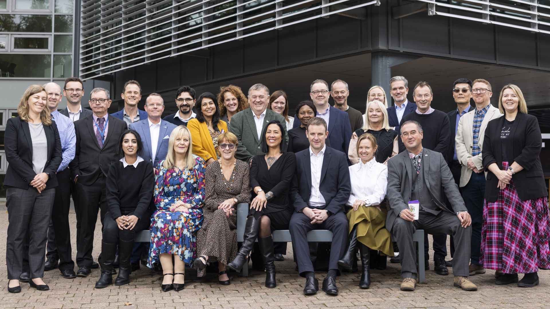 Group photo of all staff outside of the business school