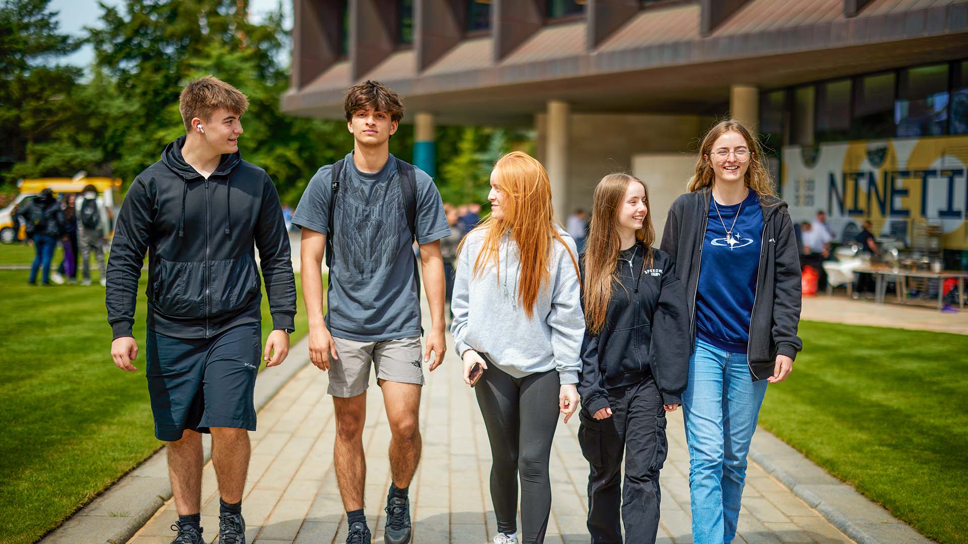 Five students walking outside Catalyst