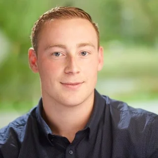 profile photo of oliver on a green background wearing a navy shirt