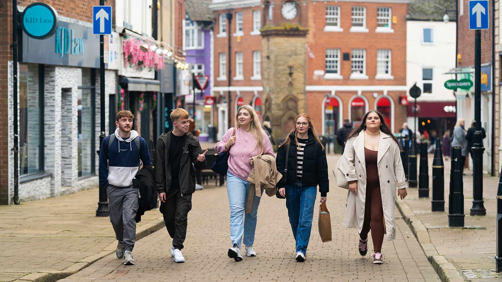 Students talking together while walking through Ormskirk town centre