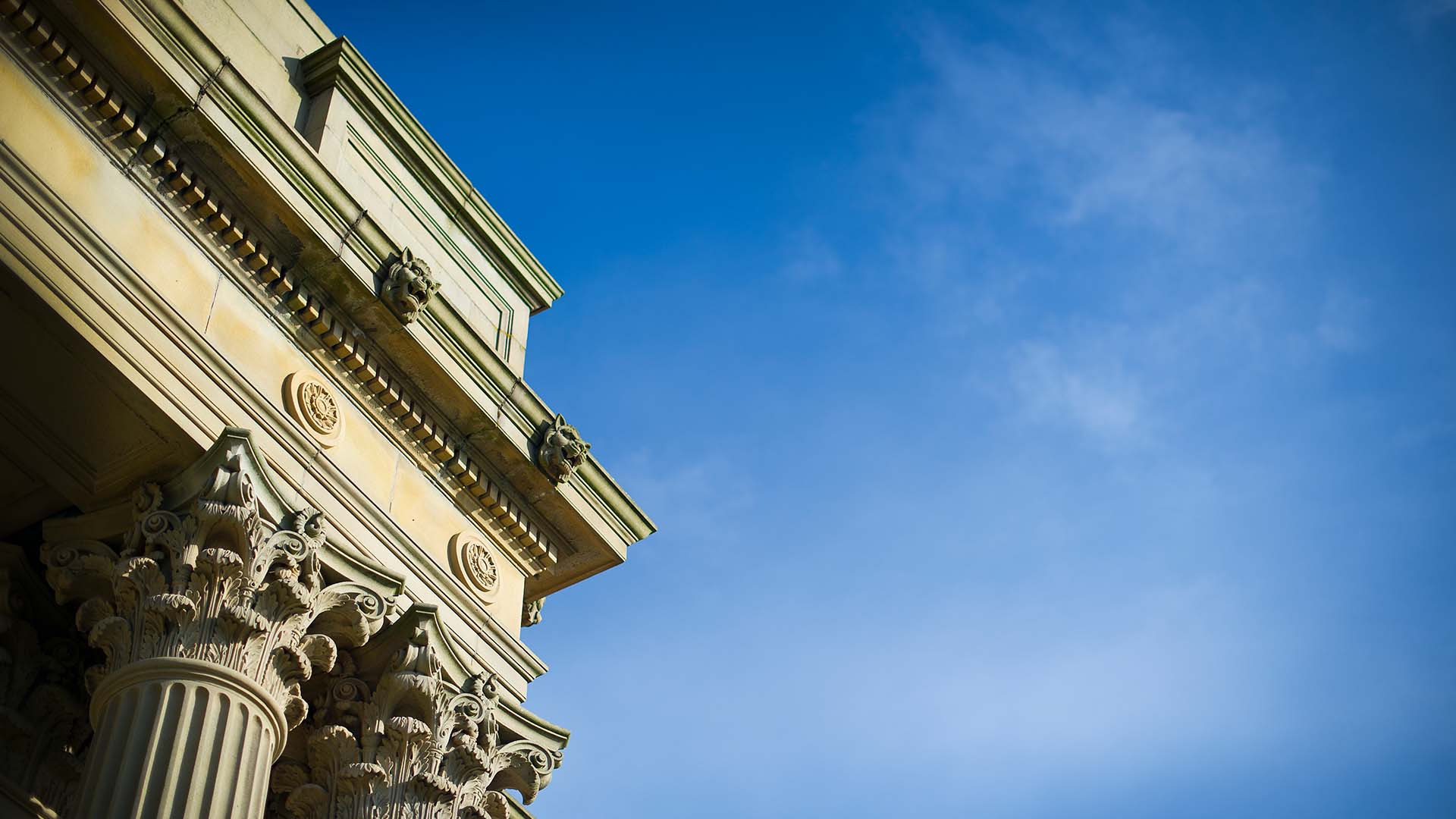 Main Building close-up, depicting columns with a blue sky.